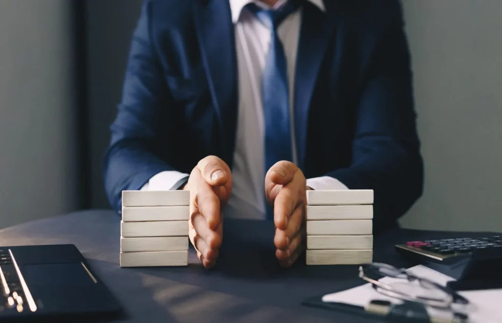  Business professional dividing assets into two equal stacks during a financial or legal settlement meeting.