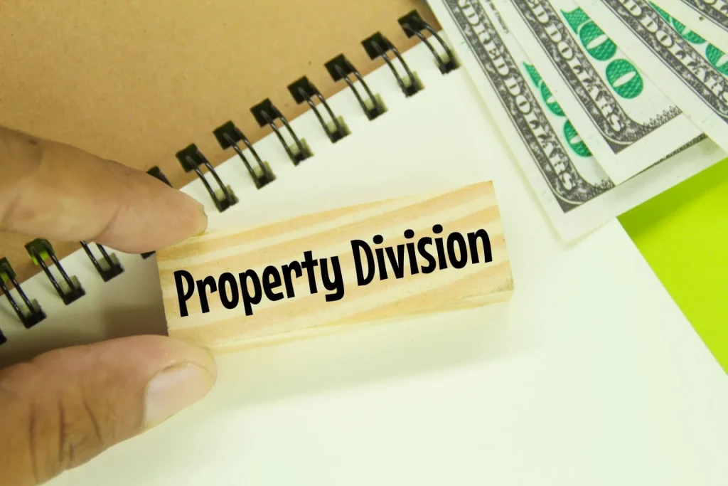 Close-up of a property division label with cash and documents, representing asset distribution in a divorce settlement.