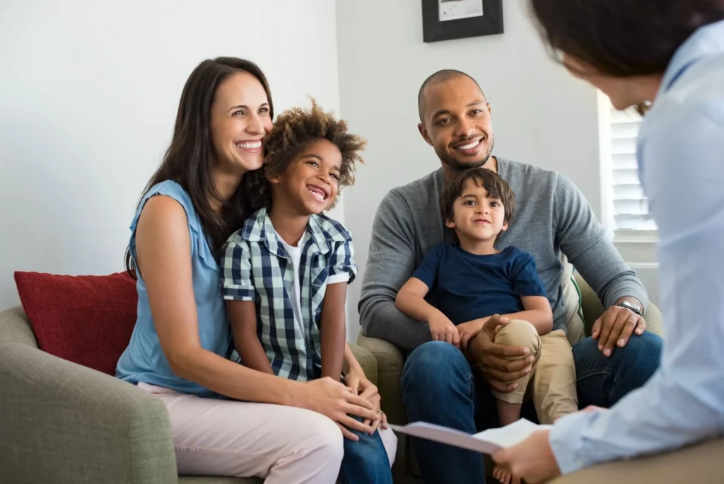 Happy family meeting with an adoption counselor during the child adoption process.
